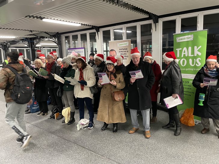 Carol singing at Ilford Station