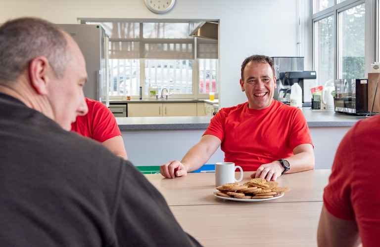 Firefighter Tom laughs in the station kitchen