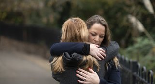 Women-hug-outdoors