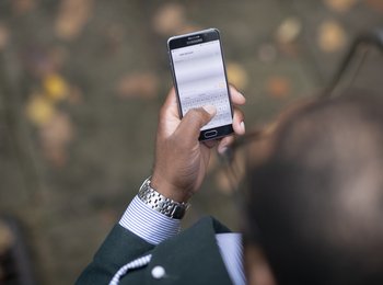 A hand holding a mobile phone