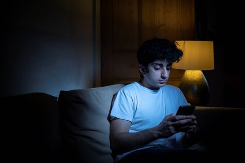 Caller on the phone using webchat with Samaritans