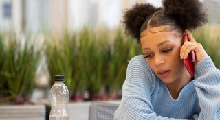 Young woman on phone to Samaritans