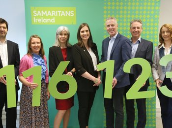 Samaritans Ireland staff holding cut out numbers that read 116 123