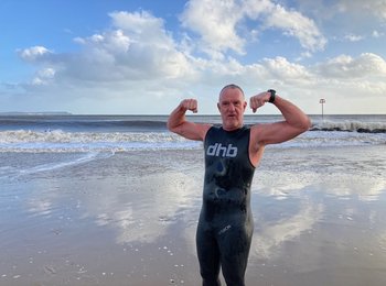 John posing for the camera by the seaside