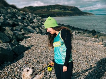 Woman in Samaritans hat with dog