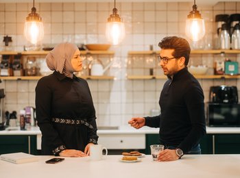 Two people having a coffee in the office