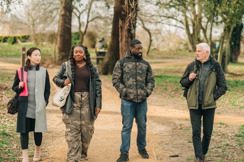 Four people stood outside talking (Outside_086_AR)