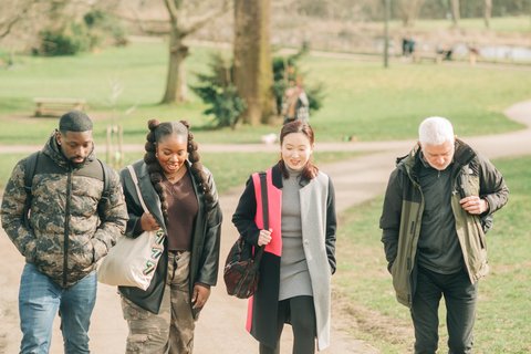 A group of people walking and smiling - Outside_123_AR