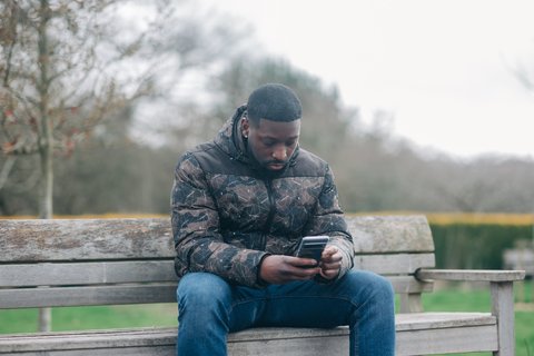 Man outside looking at his phone - Outside_337_AR