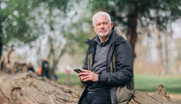 A man outside on his phone (Outside_444_AR)