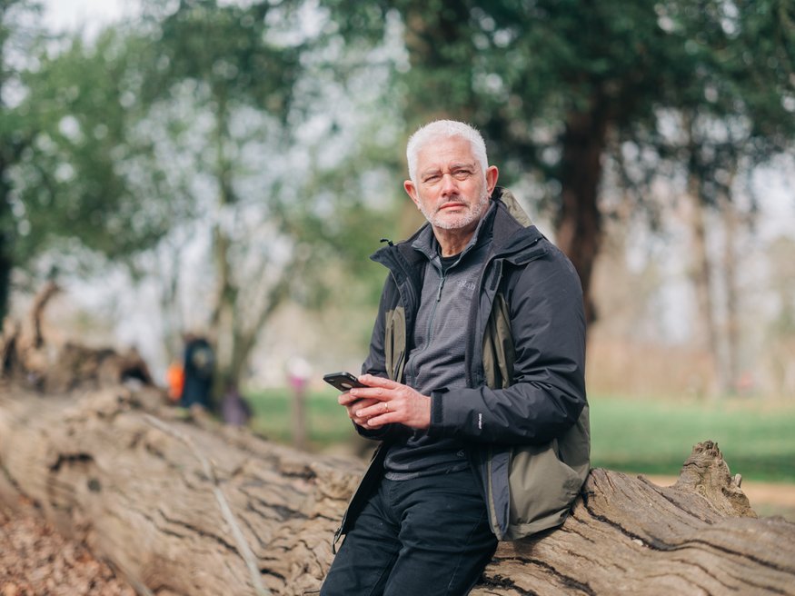 A man outside on his phone (Outside_444_AR)