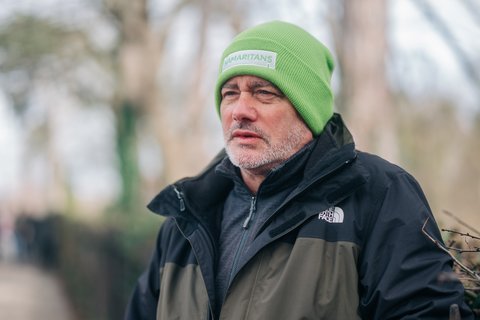 A photo of a man stood outside with a Samaritans hat on (Outside_568_AR)