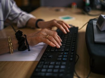 Hands typing on a laptop