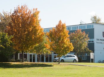 A photo of the Priory School in Hitchin, showing the grounds leading up to the main entrance