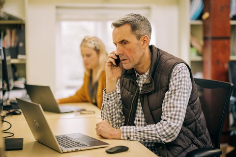 Office man on computer and phone