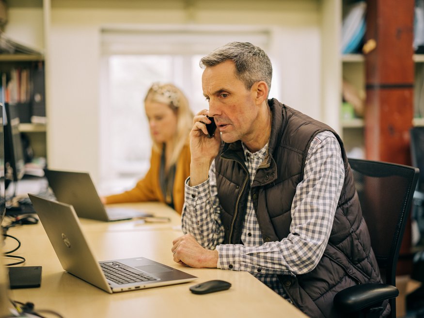 Office man on computer and phone
