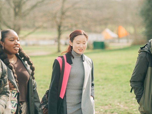 a-group-of-friends-walking-through-a-park