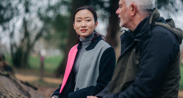 A man and a woman having a chat outside
