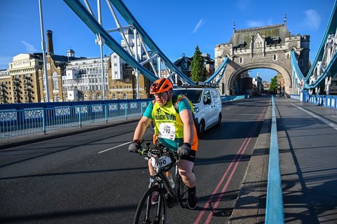Alan cycling on the Tower Bridge in London