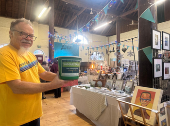 a volunteer with a donation bucket
