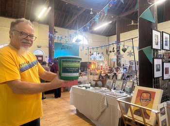 a volunteer with a donation bucket
