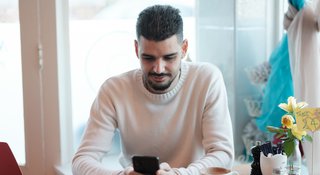 Man on phone in cafe