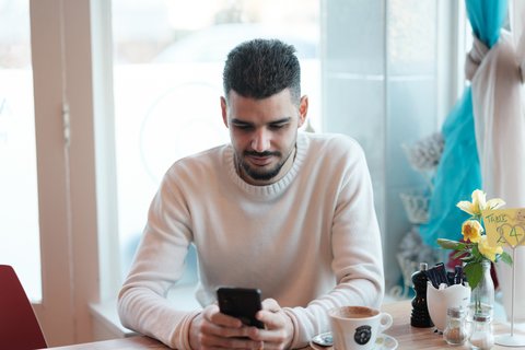 Man on phone in cafe