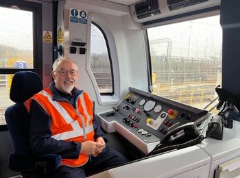 Don sitting in the drivers seat of a train