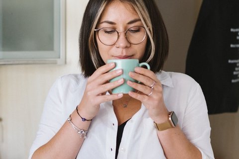 Woman drinking brew stock image