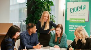Instructor talking with participants at STEP workplace training