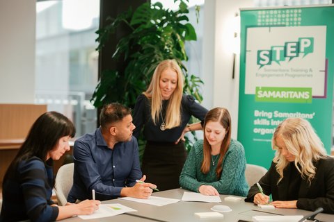 Instructor talking with participants at STEP workplace training