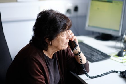 samaritans woman volunteer taking a phone call
