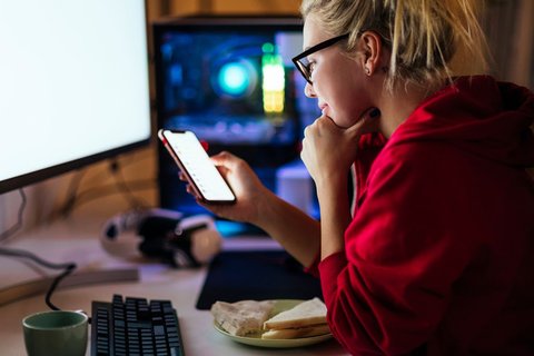 Woman on computer and phone